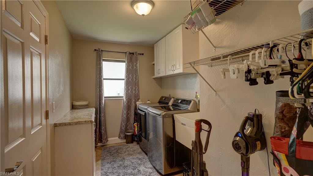Dedicated laundry room featuring built-in cabinetry, wire shelving, and a window for natural light