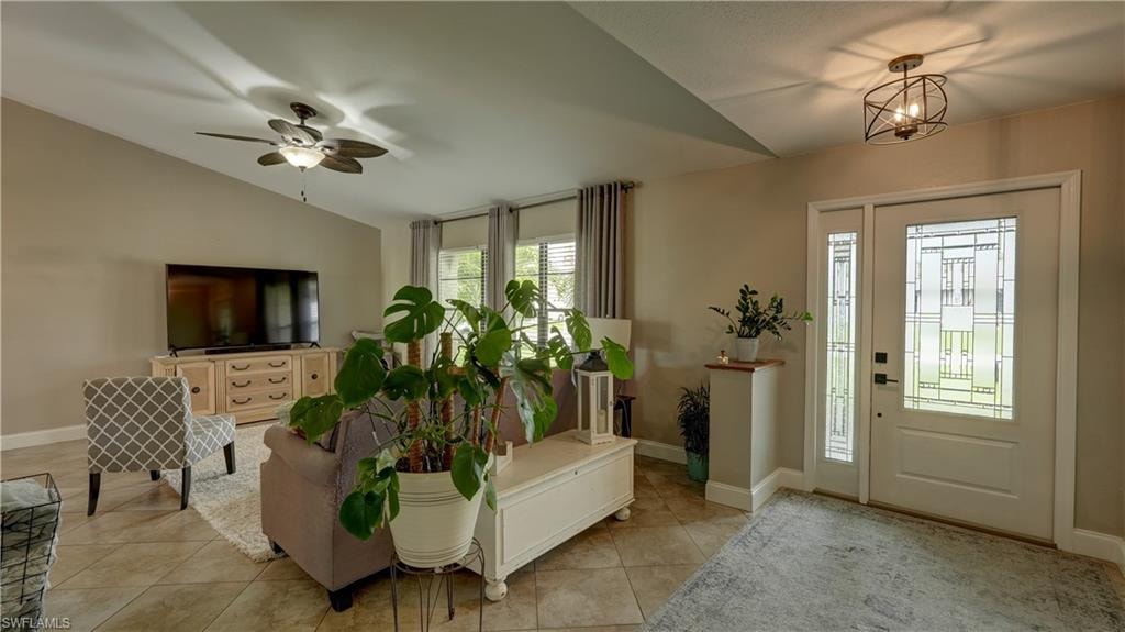 Entryway featuring a white door with decorative glass, sidelight, and a geometric flush-mount light fixture