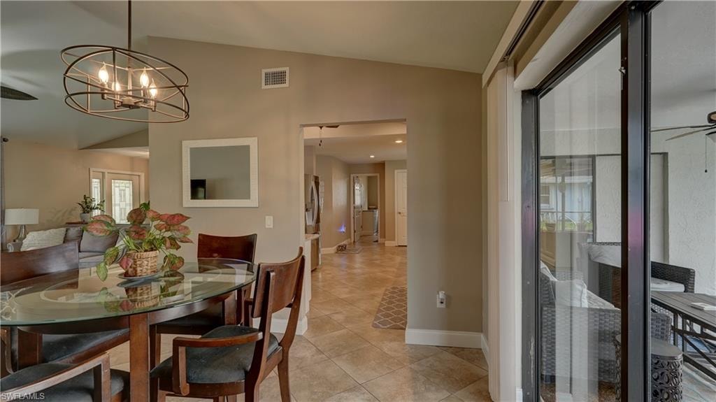 Dining area featuring a contemporary overhead light fixture, tiled flooring, and neutral wall paint