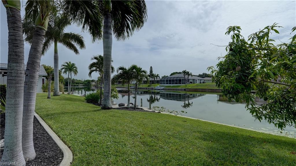 Canal-front property featuring extensive green lawn