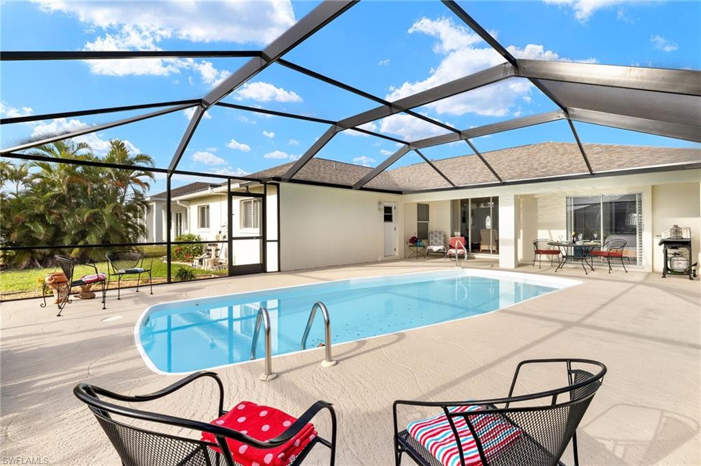 Swimming pool with a sunroom, a patio area, and a lanai