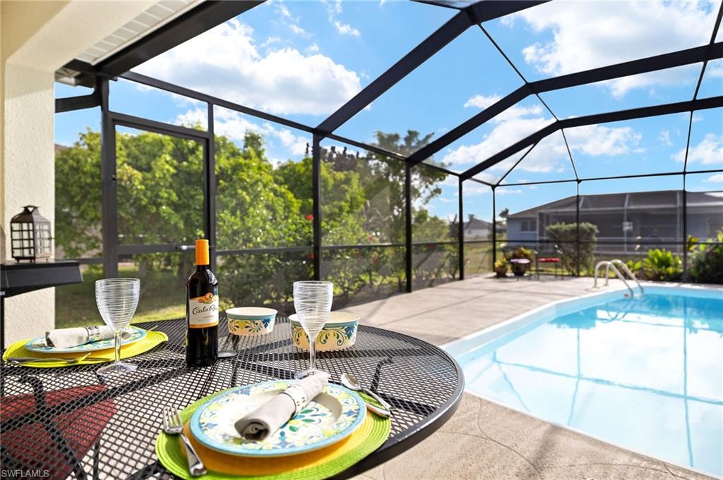 Outdoor pool with a sunroom and glass enclosure