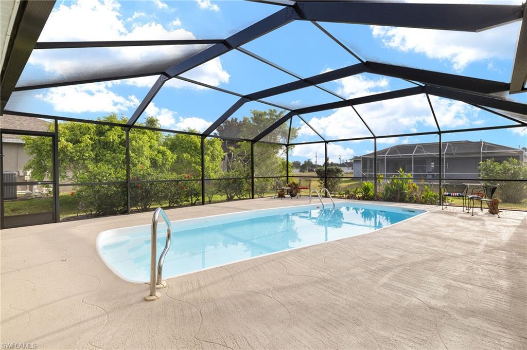 Swimming pool with a sunroom, a lanai, and a patio