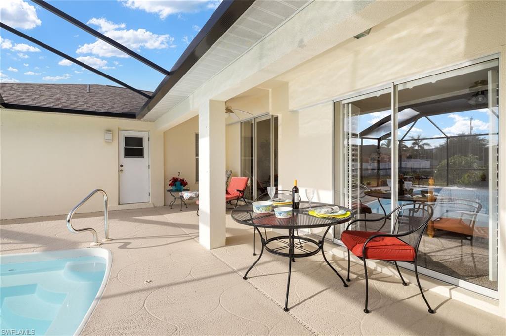 View of patio / terrace with glass enclosure, a sunroom, and a ceiling fan