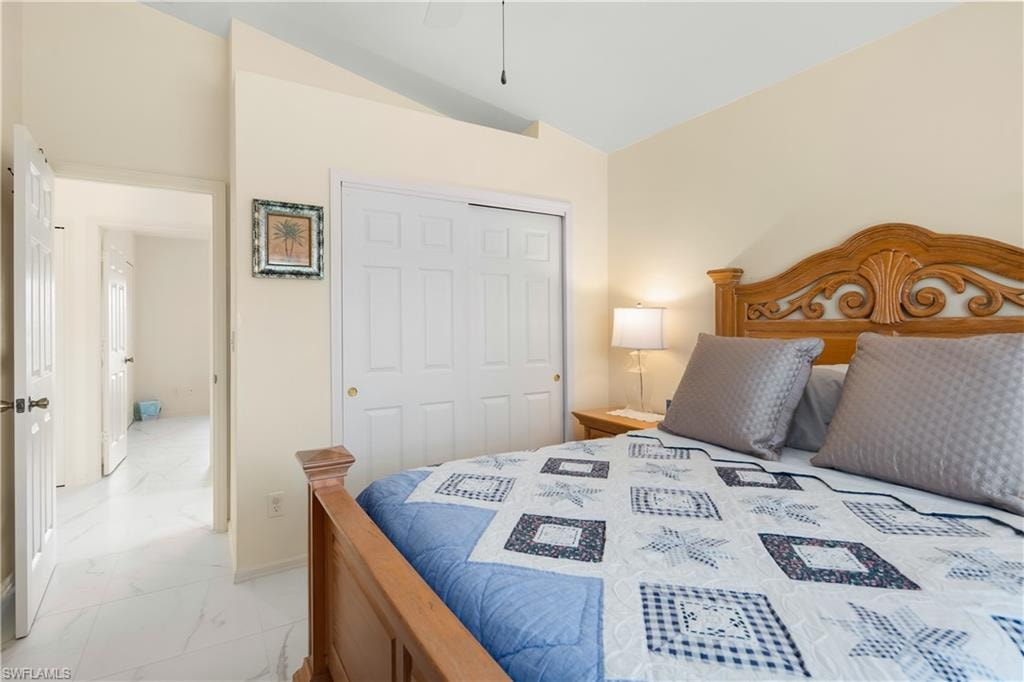 Bedroom featuring a vaulted ceiling and neutral wall tones