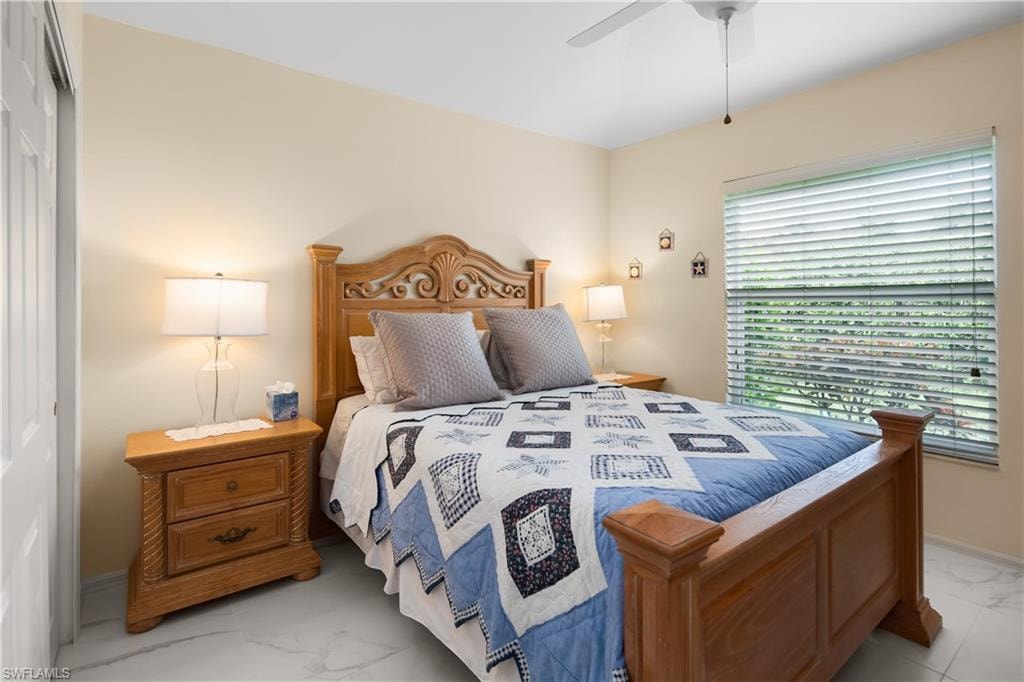 Bright room featuring a ceiling fan, a window with horizontal blinds, and light-toned walls
