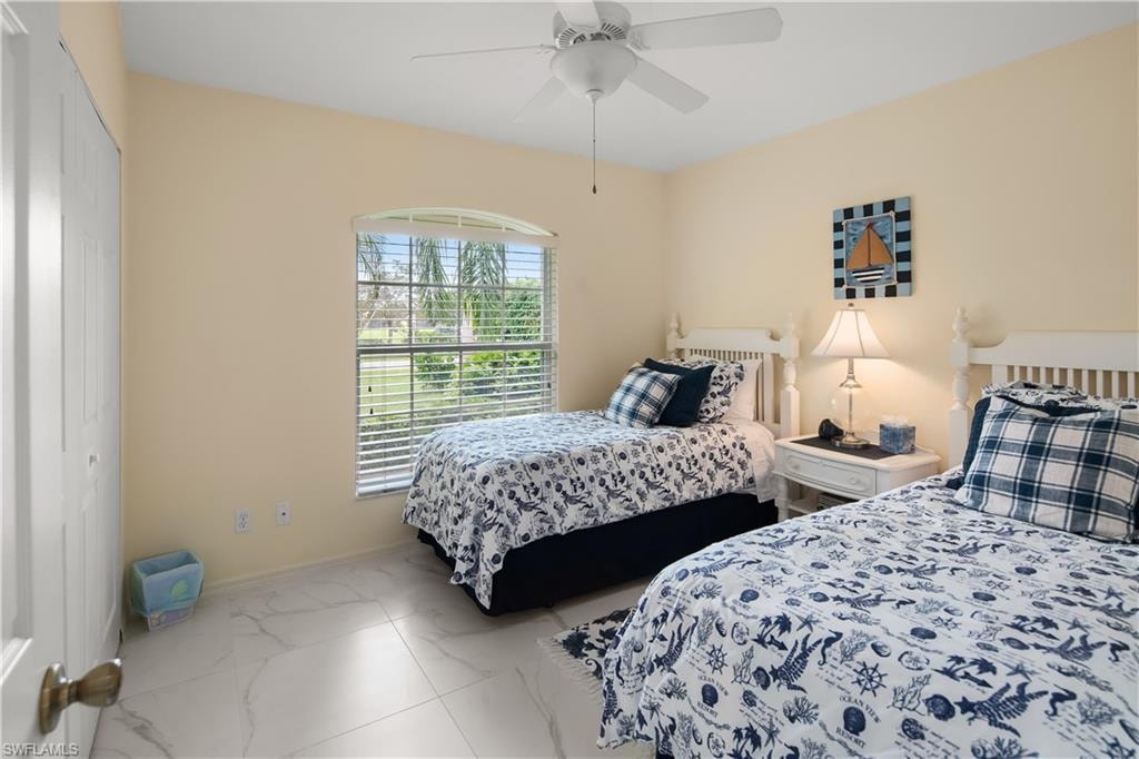 Bedroom with light neutral wall tones and white tile flooring