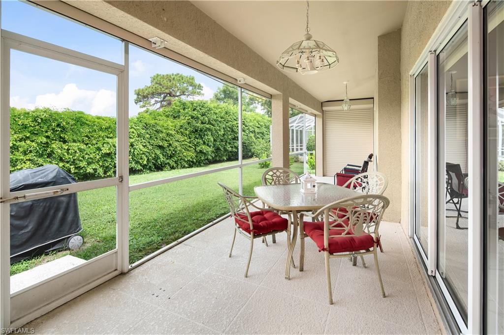 Screened patio featuring a textured ceiling with a pendant light fixture, and a tile floor