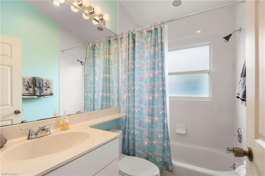 Bathroom featuring a single vanity with an integrated sink, polished chrome faucet, and a large mirror