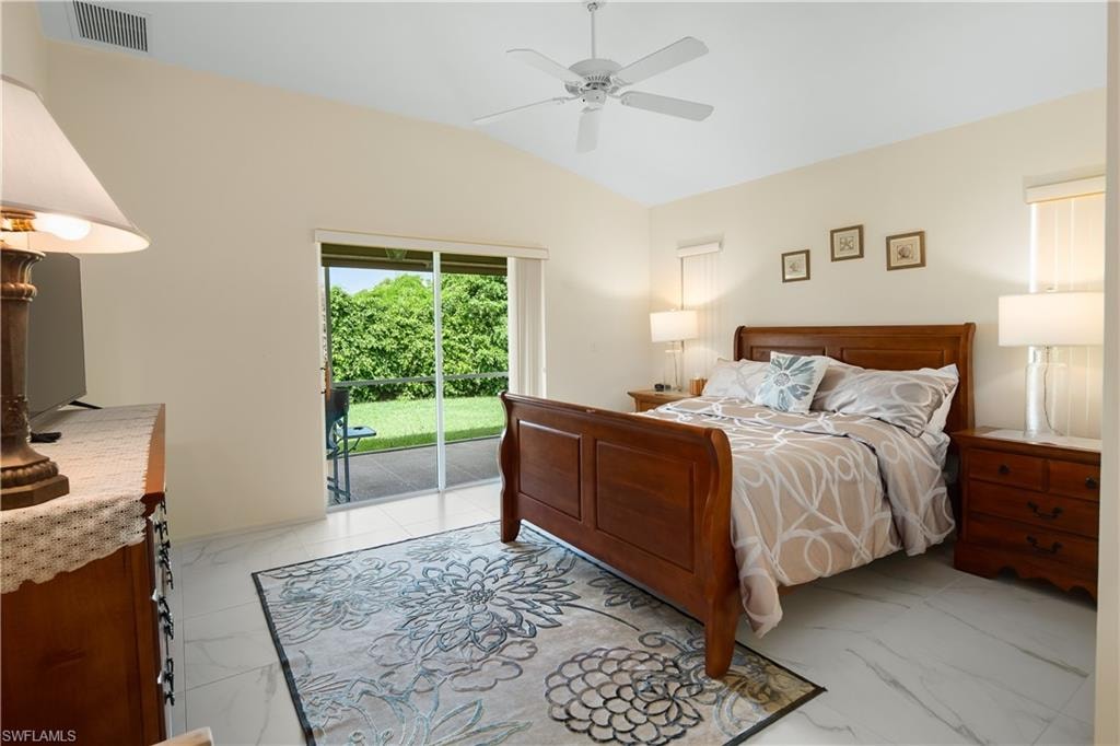 Spacious bedroom featuring vaulted ceilings, a ceiling fan, and white tile flooring
