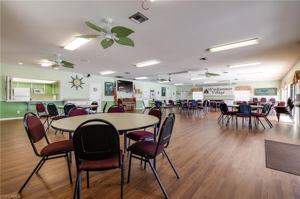 Spacious common area featuring wood-finish flooring, recessed lighting, and multiple ceiling fans