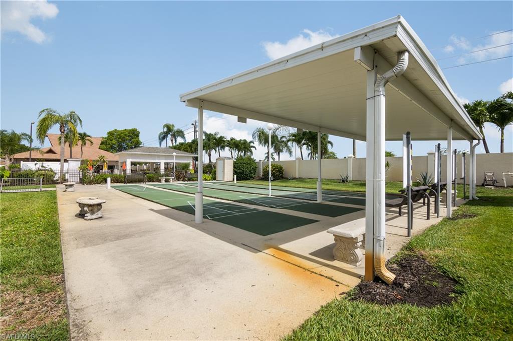 Outdoor recreational space featuring multiple shuffleboard courts