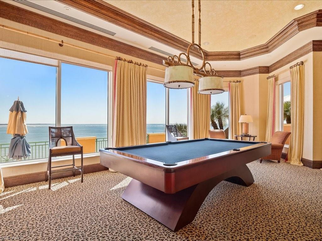 Recreation room featuring a water view, ornamental molding, and billiards table