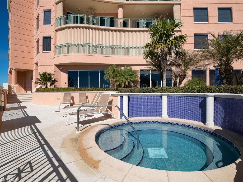 View of swimming pool with a community hot tub