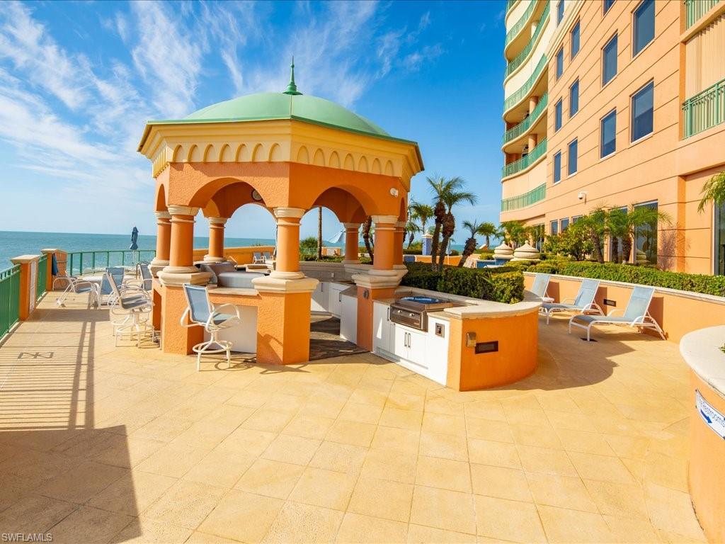 View of patio featuring an outdoor kitchen and a water view