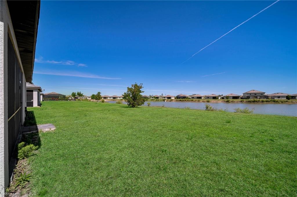 View of yard with a water view