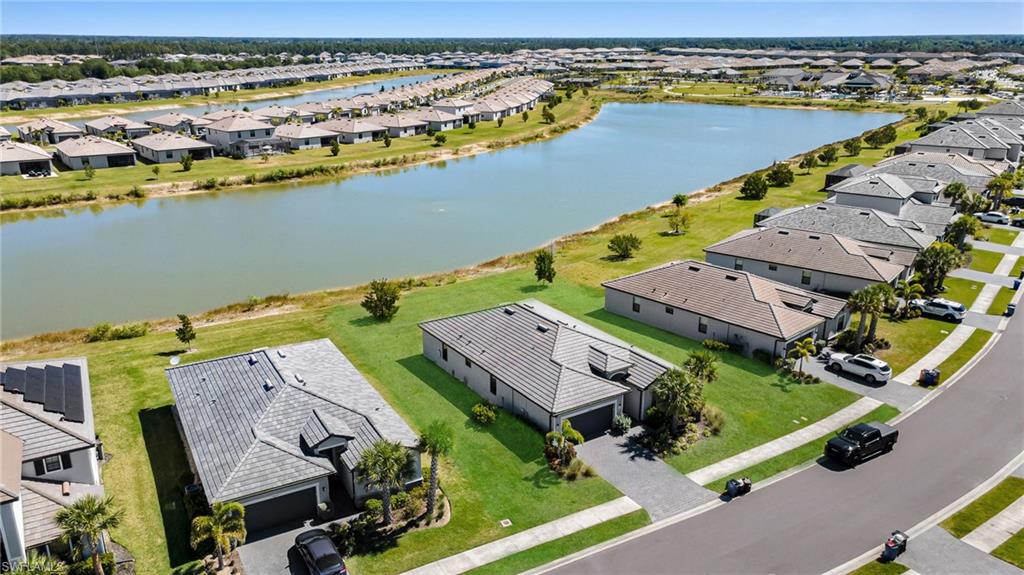 Drone / aerial view with a water view and a residential view