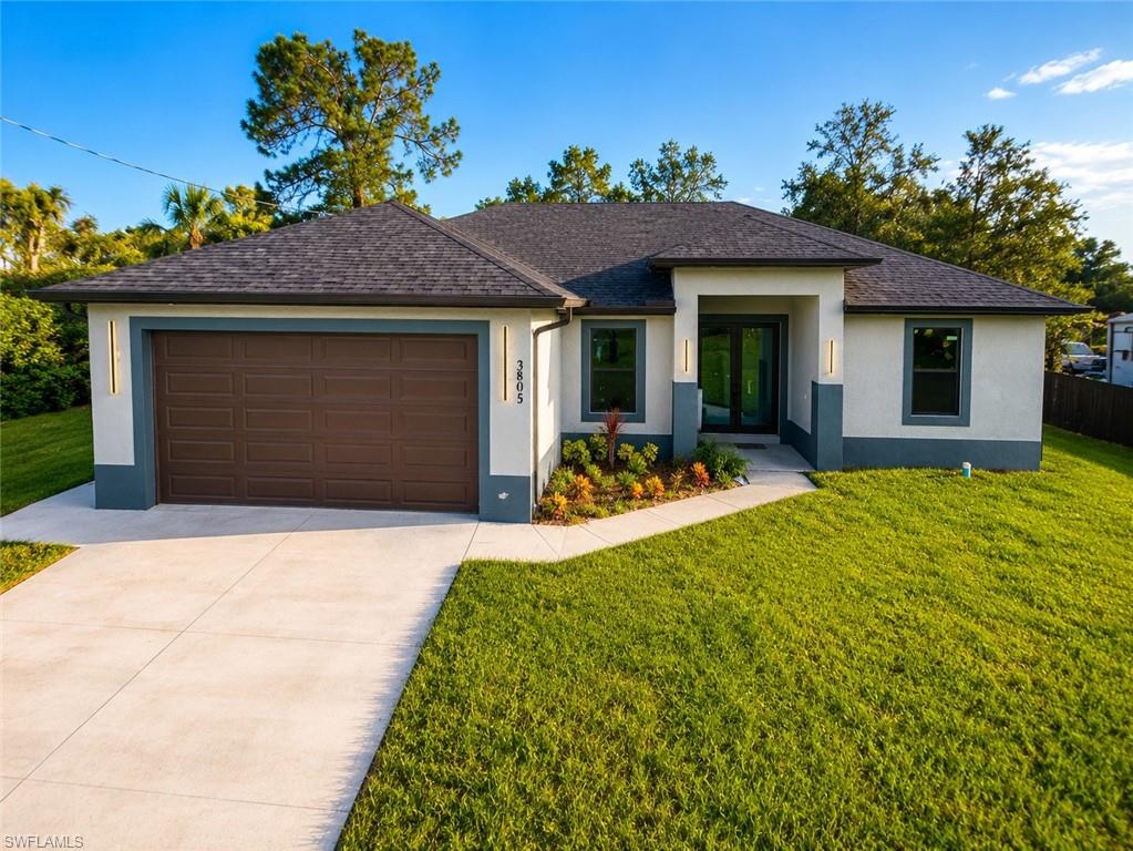 Contemporary facade with a dark gray shingle roof, two-tone stucco exterior, a dark brown paneled garage door, and a concrete driveway