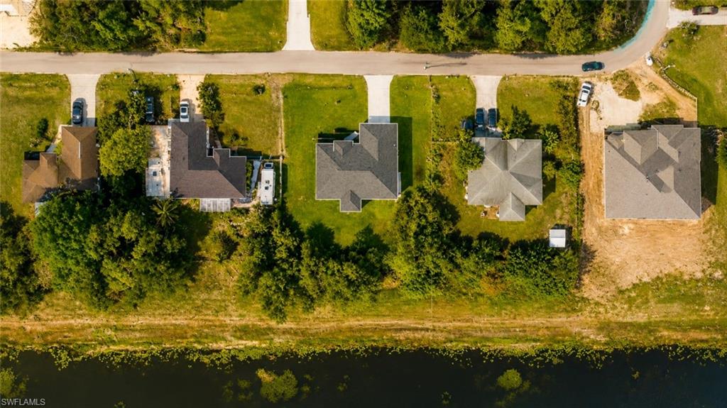 Aerial perspective showcasing multiple residential properties along a paved road
