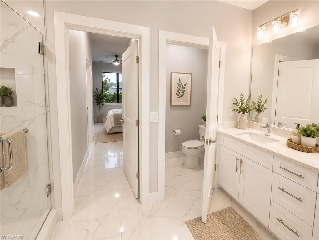 Bathroom featuring a white vanity with an dual sink, polished chrome faucet, and light-colored countertop