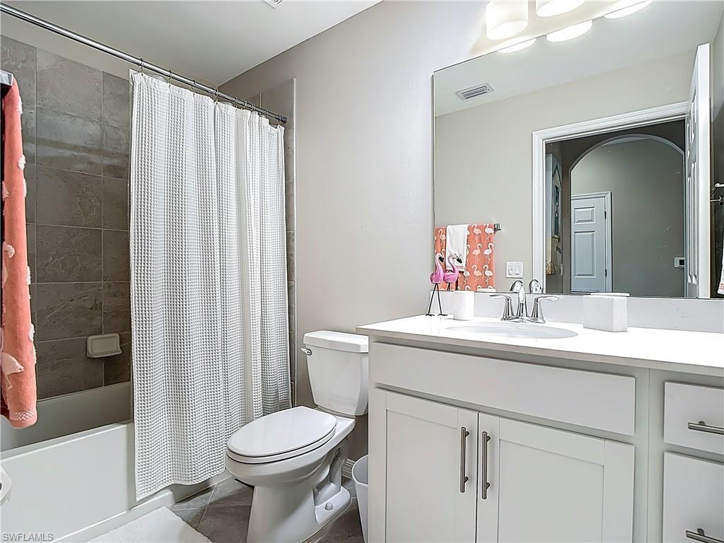 Full bathroom featuring vanity and shower / bath combo with shower curtain