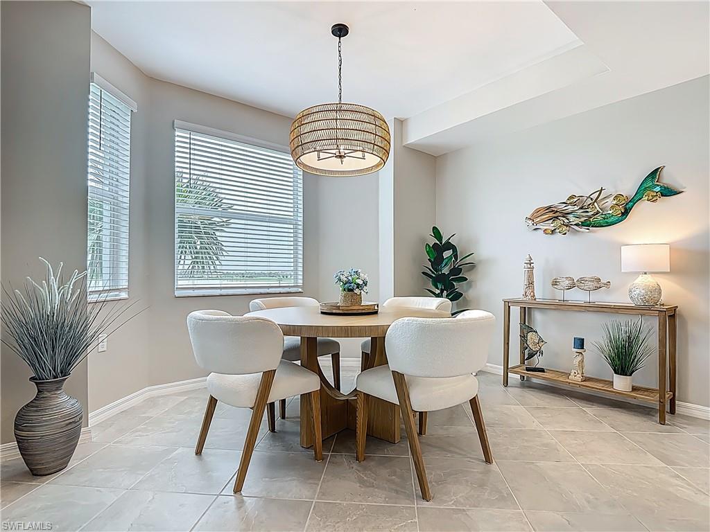 Dining room with a chandelier and baseboards
