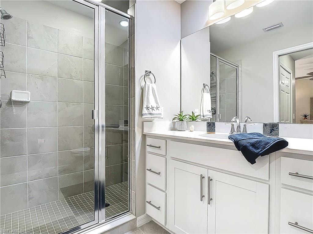 Full bathroom featuring a shower stall and vanity