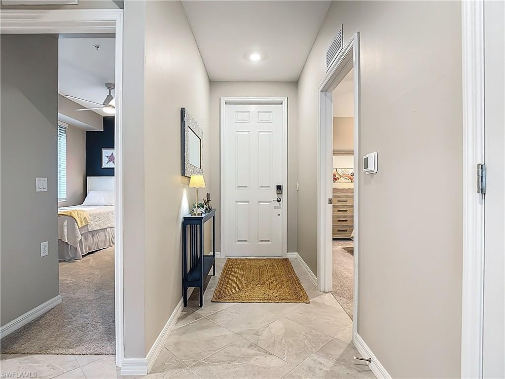 Hall featuring baseboards