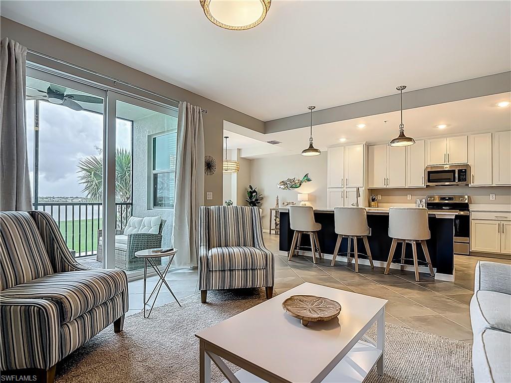 Living area featuring light tile patterned floors and recessed lighting