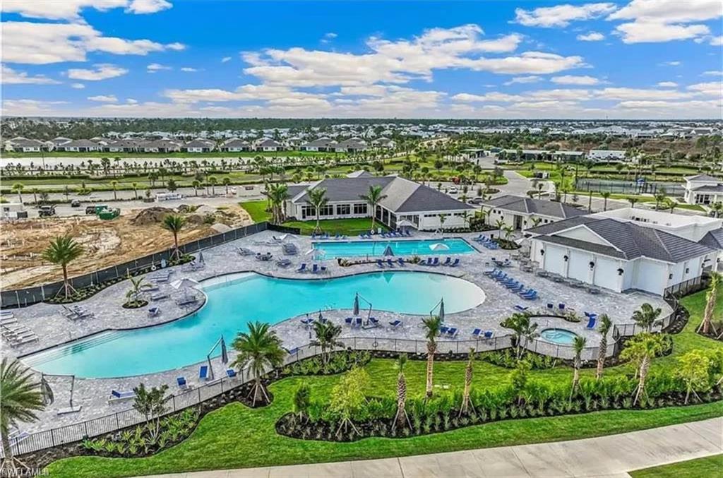 Aerial view of residential area featuring a pool area
