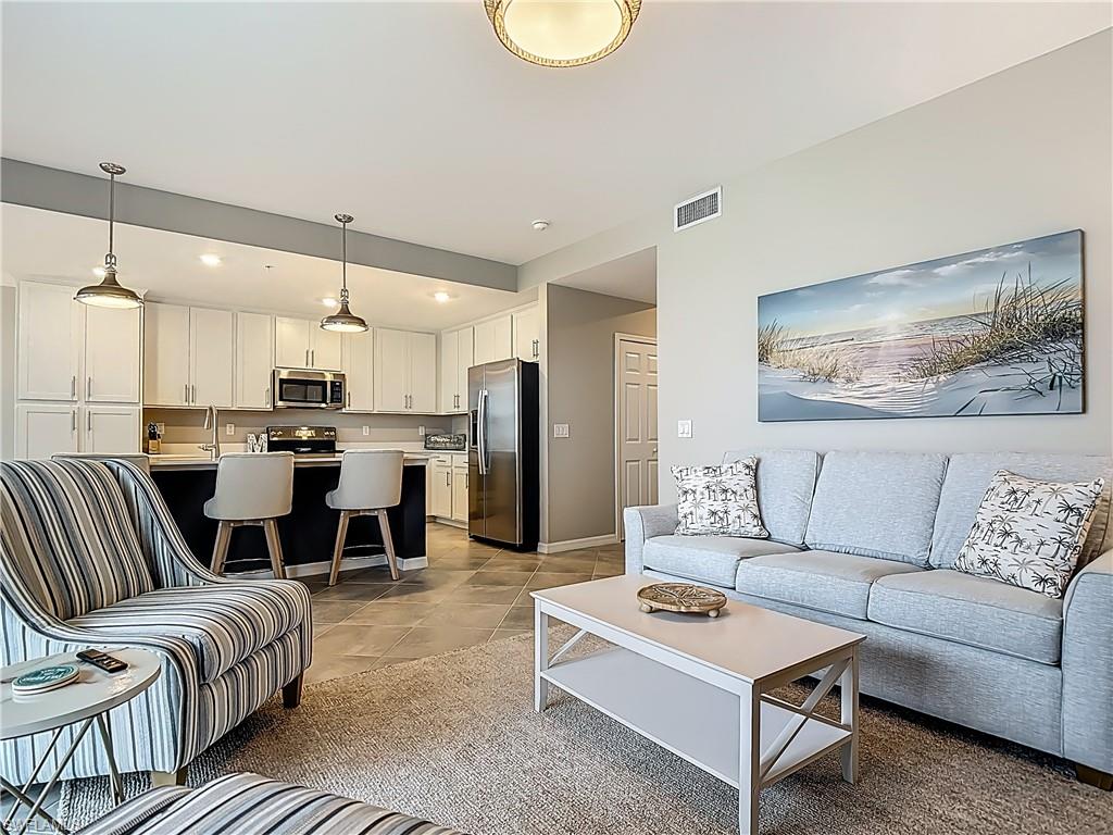 Living area featuring light tile patterned flooring and baseboards