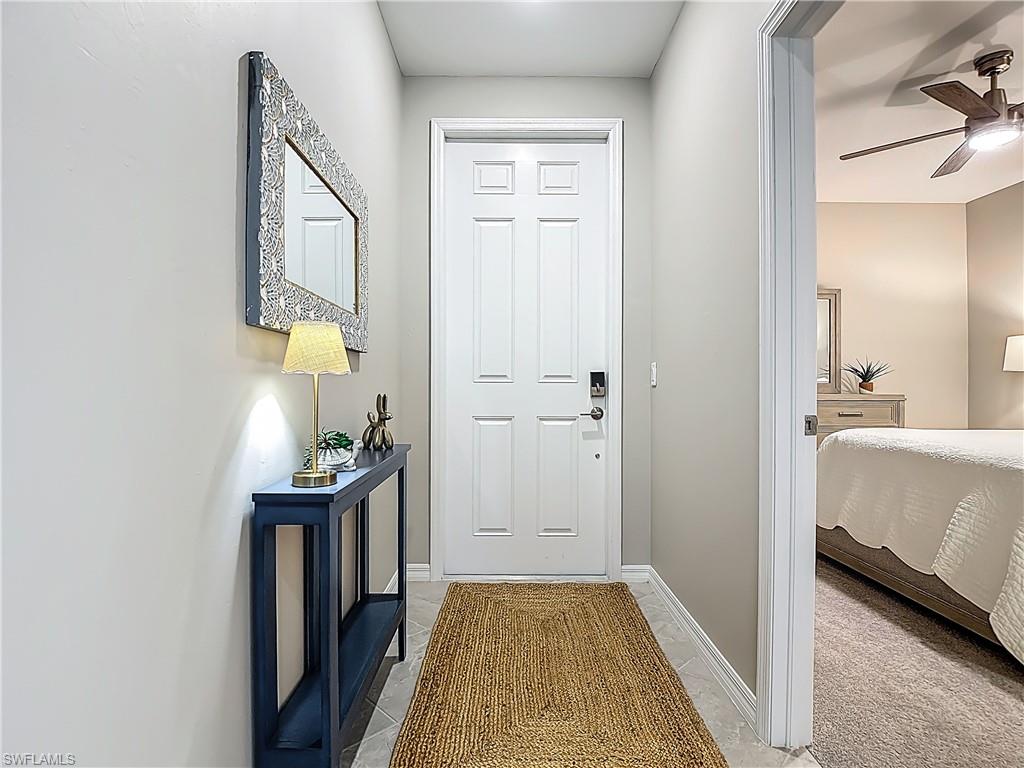 Entryway with a ceiling fan and baseboards