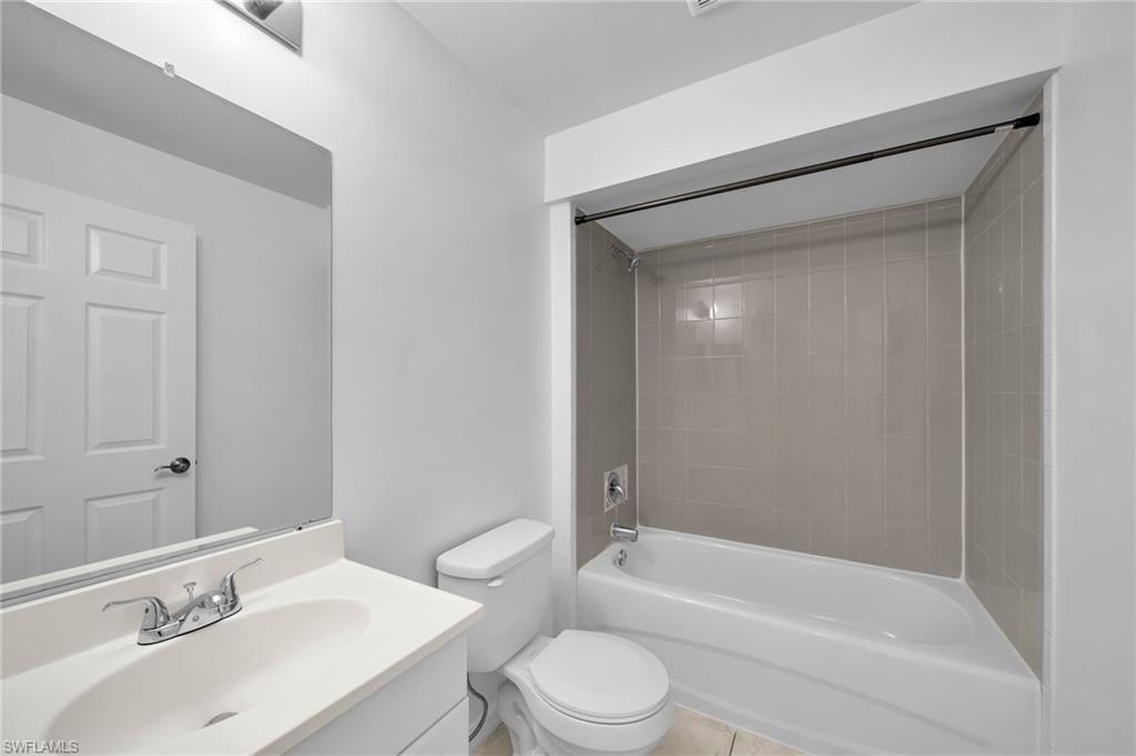 Bathroom featuring a vanity with an integrated sink, polished chrome faucet, and overhead lighting