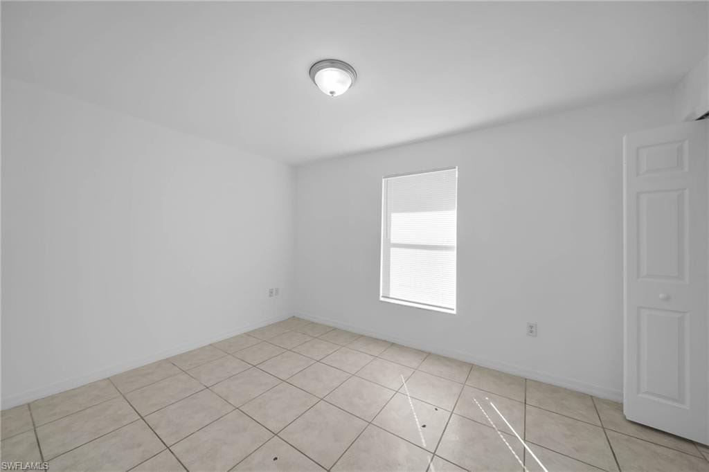 Bright interior space featuring light-colored tile flooring