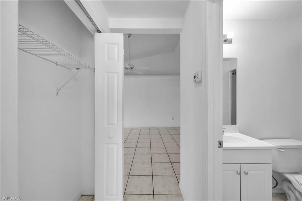 Entryway featuring a bifold door, wire shelving, and tile flooring