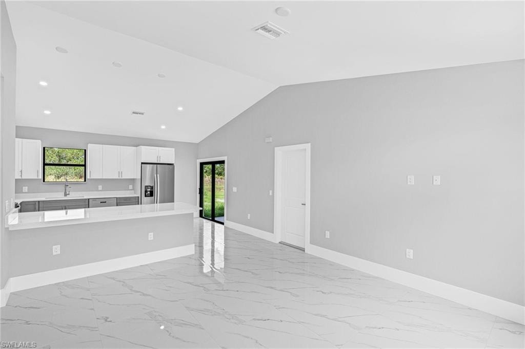 White paneled doors with matte black hardware, large window with black trim, and light gray walls