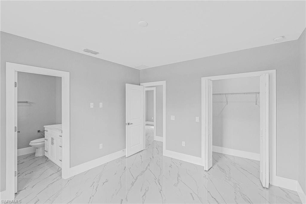 White walls with a light marble-look tile floor