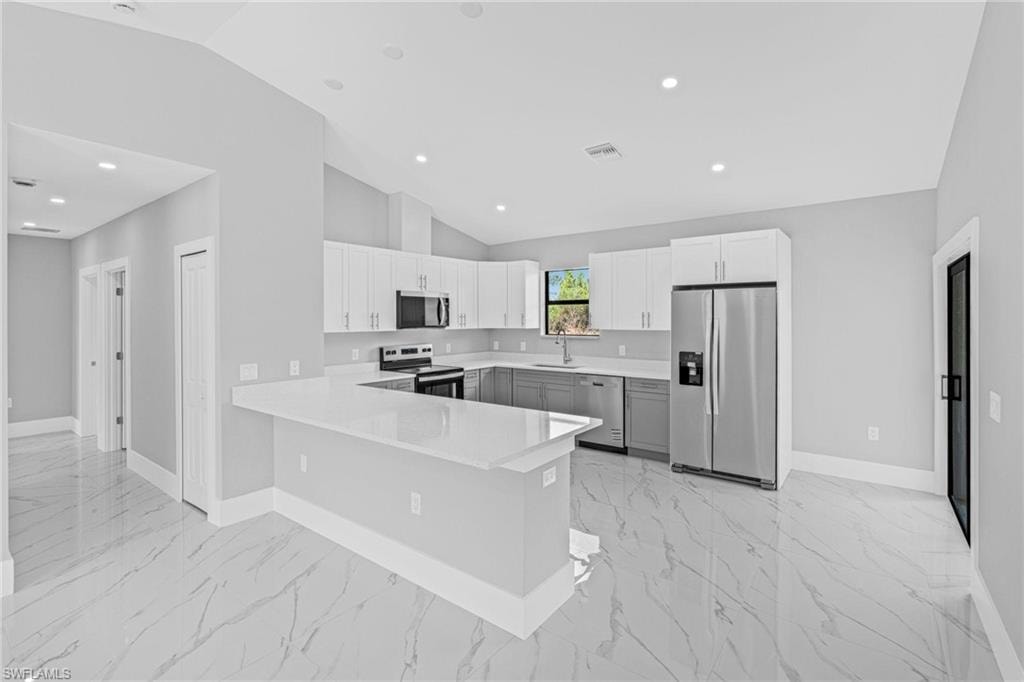 Open concept living area with vaulted ceilings