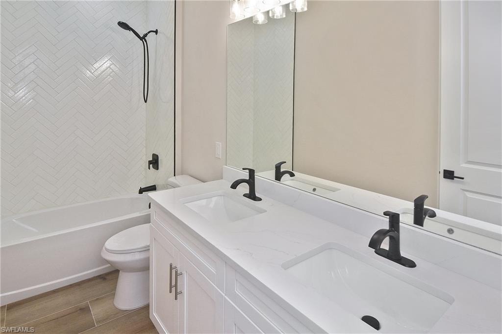 Dual vanity with integrated sinks, white cabinetry, and a light-toned countertop