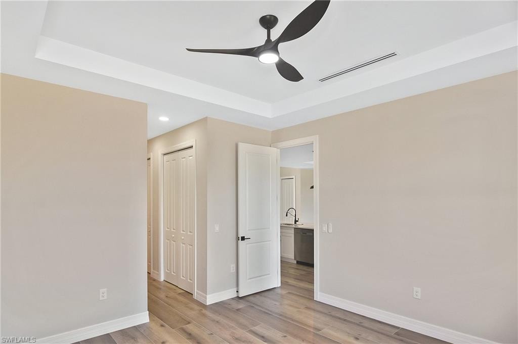 Tray ceiling with a modern black ceiling fan