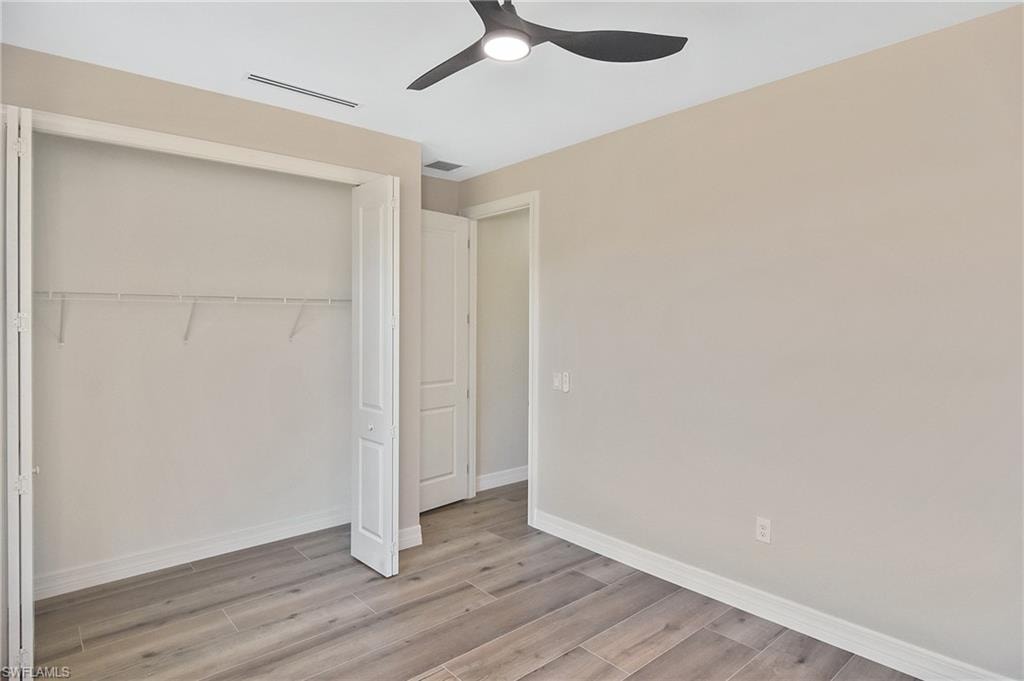 Light gray wood-finish flooring complements neutral wall tones in this interior space