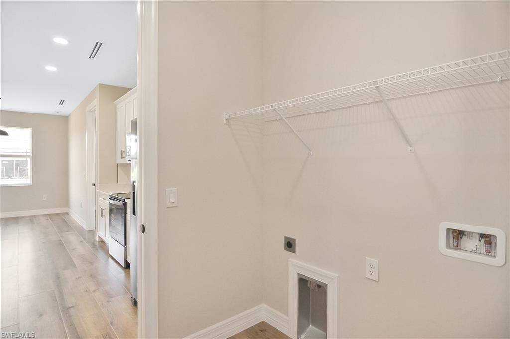 Dedicated laundry area featuring a wire shelf, utility sink hookup, and appliance hookups