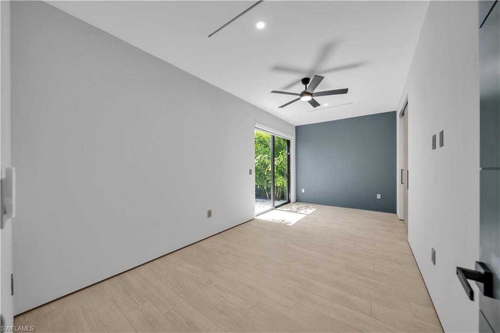 Light wood-finish flooring complemented by a feature wall in a deep matte finish