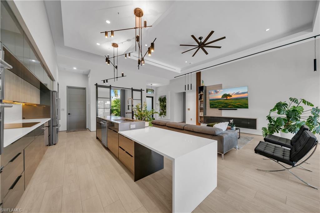 Open-concept kitchen and living area featuring light wood-finish flooring