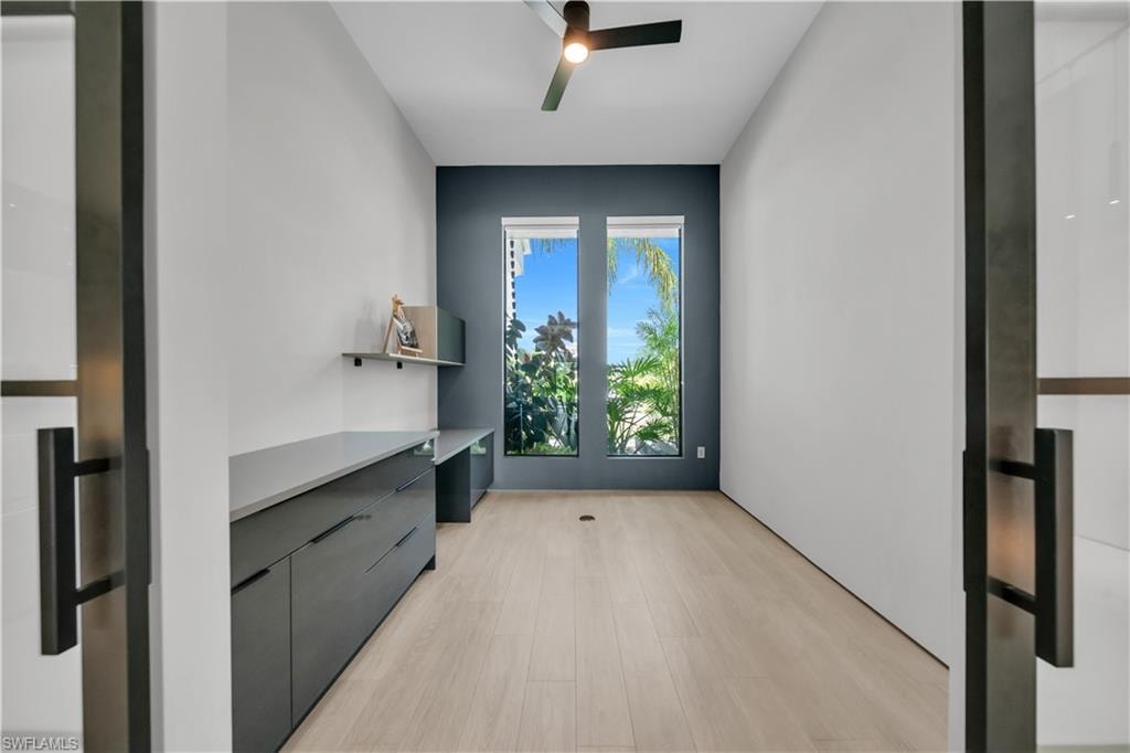 Room featuring light wood-finish flooring and a ceiling fan