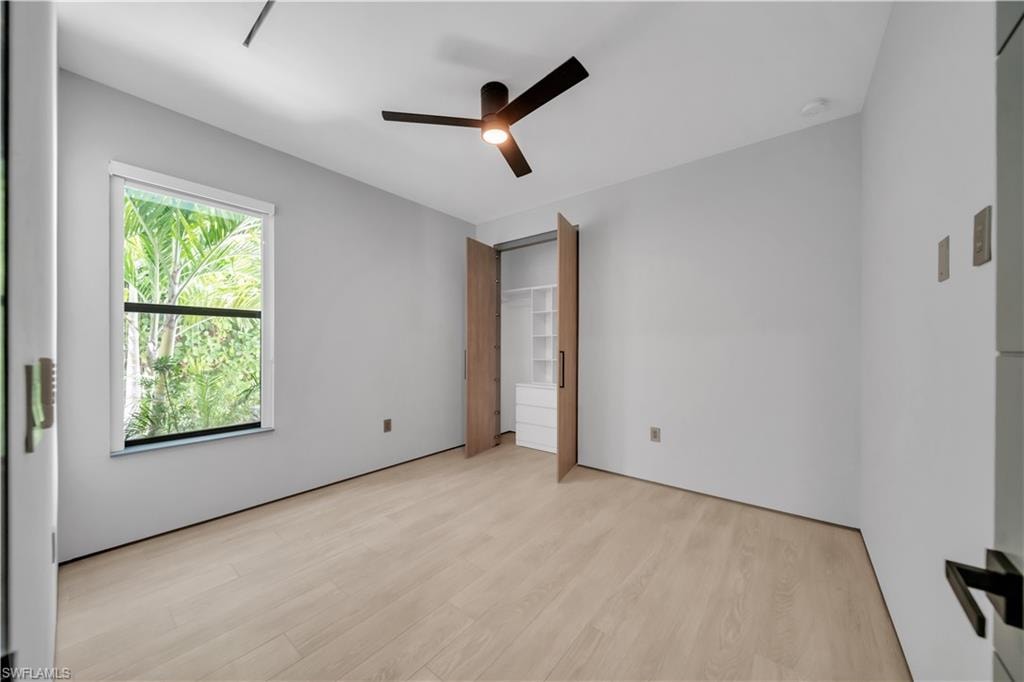 Light wood-finish flooring complements the neutral wall tones