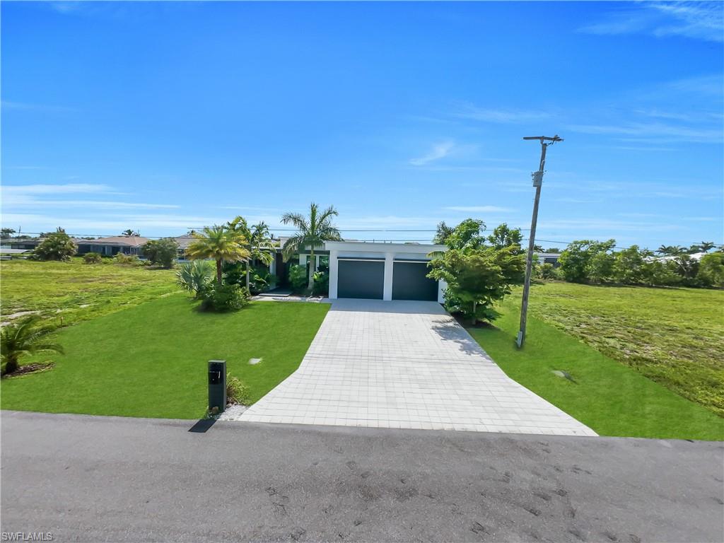 Modern single-story residence with a two-car garage and a paver driveway