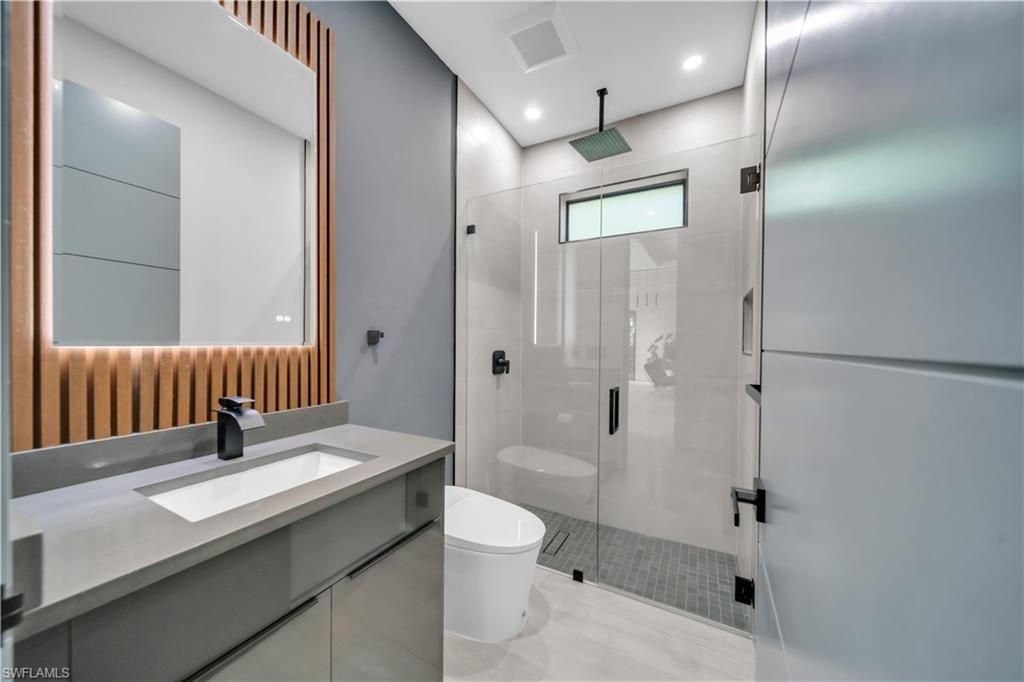 Contemporary bathroom featuring a floating vanity with integrated sink, matte black faucet, and concrete-finish countertop