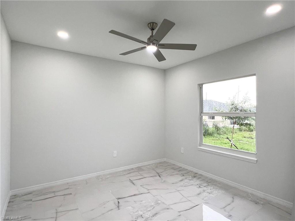 Room featuring large-format tile flooring, a ceiling fan with integrated lighting, and recessed ceiling lights