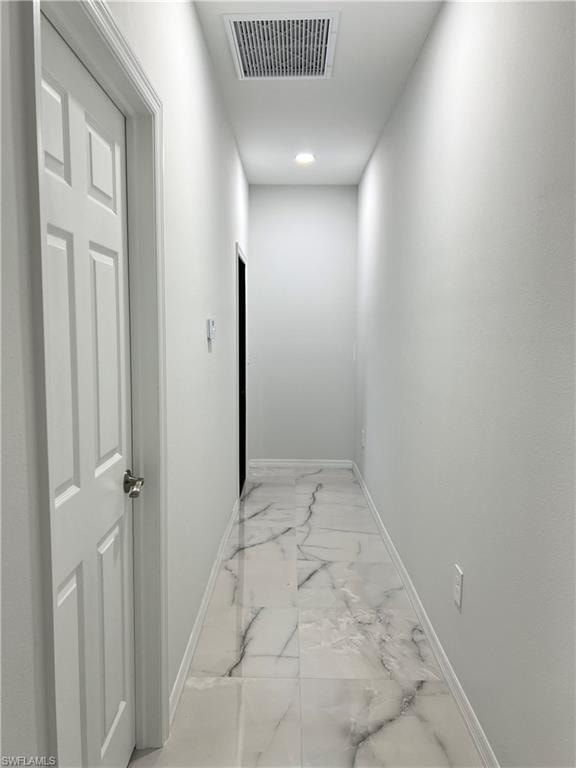 Hallway featuring white panel doors, recessed lighting, baseboard trim, and large format tile flooring